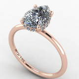 14K rose gold engagement ring featuring a pear-cut 2-carat gemstone, surrounded by delicate accent stones for a dazzling, elegant finish.