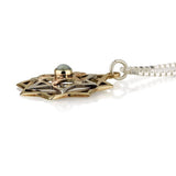 "Eve's Repair" pendant, silver and gold, set with chrysoberyl